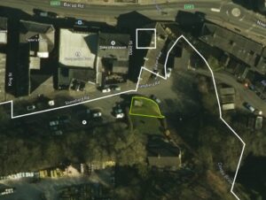 Property for sale Aerial view of a street with parked cars, buildings, and roads labelled Stansfield Rd and Bacup Rd; near the Baron Pumping Station Waterfoot, a small green area outlined in yellow suggests an urban redevelopment opportunity in Rossendale. Presented by Palace Auctions