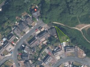 Property for sale A satellite view of a residential area with houses, roads, and greenery. A triangular plot of land is outlined in yellow—this Cheshire East infill plot is adjacent to Pine Grove and close to woodland footpaths. Presented by Palace Auctions