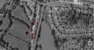 Property for sale A black-and-white aerial view of a suburban area with houses and green spaces. A section near a railway line is outlined in red. A north arrow is in the bottom right corner. Presented by Palace Auctions