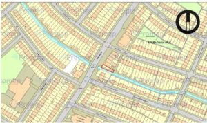 Property for sale A map of Streatham Vale displays rows of houses and a narrow blue waterway running through the neighbourhood. One plot of land near the river bank is outlined in red, with a compass in the upper right corner and “Streatham Vale” labelled. Presented by Palace Auctions